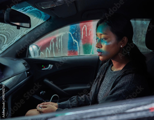 Woman driving car at night time.