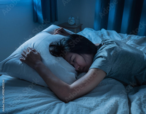 Woman sleeping peacefully on bed.