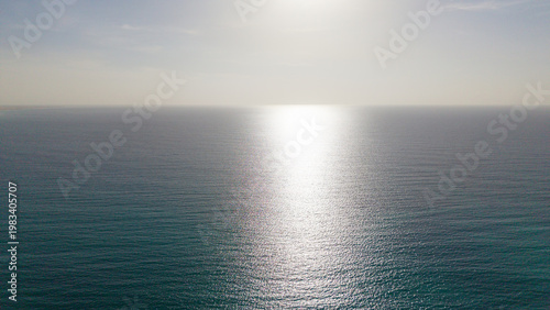 Sunlight reflection on calm open ocean horizon
