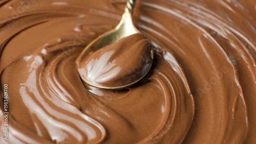 Macro shot of glossy delicious cocoa nut butter on spoon