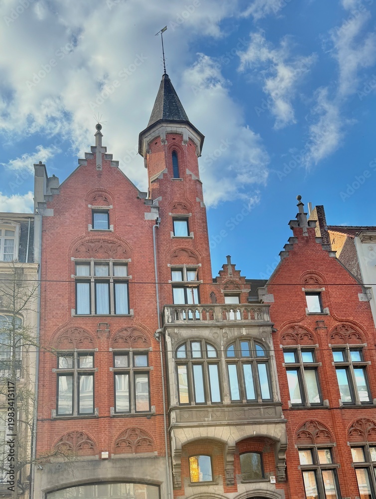 Obraz premium Stunning Neo-Gothic Red Brick Architecture with Ornate Turret and Spire