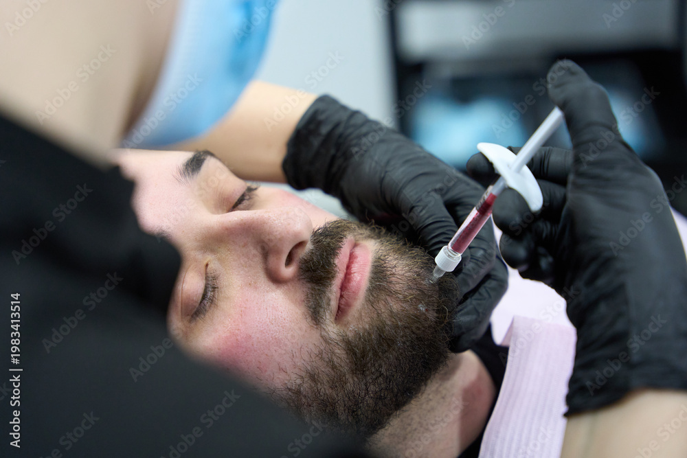 Fototapeta premium Man receiving dermal filler injection for skin rejuvenation