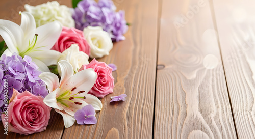 Elegant bouquet of lilies roses and hydrangeas arranged on rustic brown wooden table.