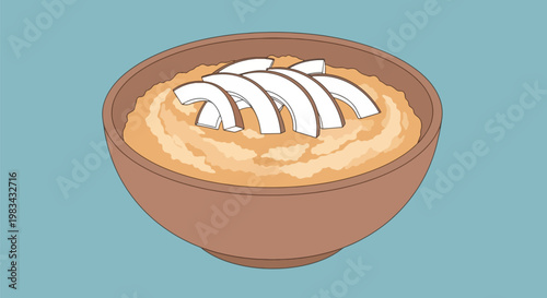 Bowl of Oatmeal Topped with Coconut Slices.