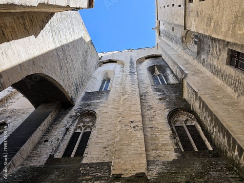 фотографія Massive stone walls and gothic windows of the Palais des Papes in Avignon