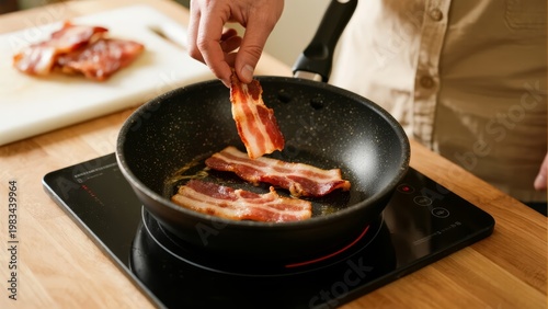 Cooking bacon in a frying pan on an induction stove