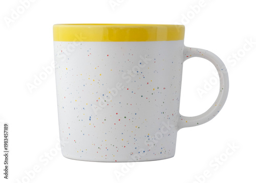 A white mug with a yellow rim. The surface is covered with a speckled pattern of numerous small colored dots. The background is solid