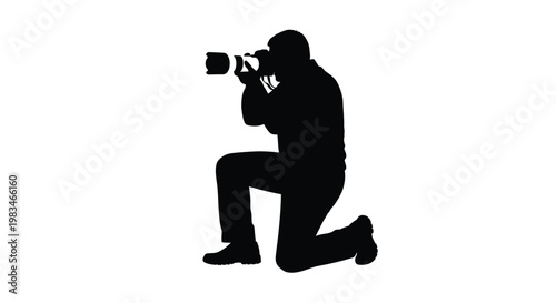 Silhouette of a photographer kneeling while operating a large camera