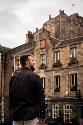 Man Looking at Edinburgh Castle from Grassmarket Square