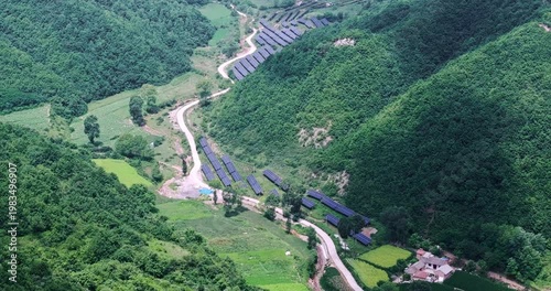 aerial view of a village and photovoltaic power station