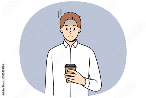 Tired business man suffering from exhaustion and burnout and holding paper cup of coffee in hands. Problems exhaustion among office employee experiencing health difficulties due to constant overtime