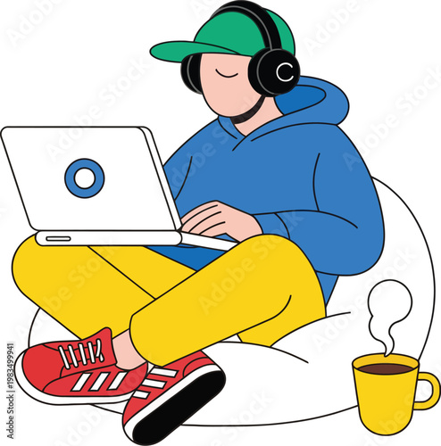 Relaxed young adult male freelancer working on laptop computer wearing headphones sitting on bean bag chair at home with coffee cup