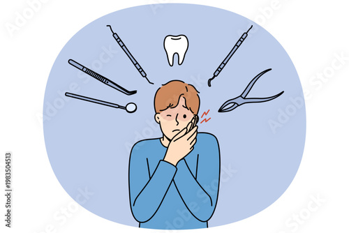 Man suffers from pain in teeth and appearance of caries, stands among dental instruments. Sick guy grabs face due to tooth pain and needs to visit dental clinic with professional doctors