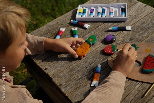 Pebbles turned into peppers, rocks into radishes. He's creating a garden that never wilts, one painted stone at a time.