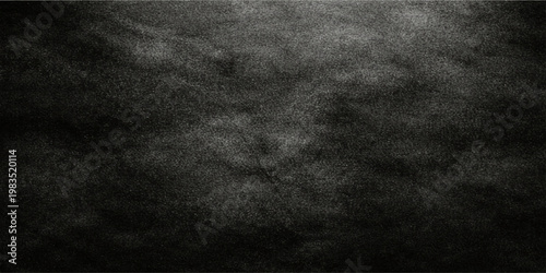 Vintage dark black fabric texture with a rough grunge pattern and a gray weathered surface for a blank chalkboard wall backdrop