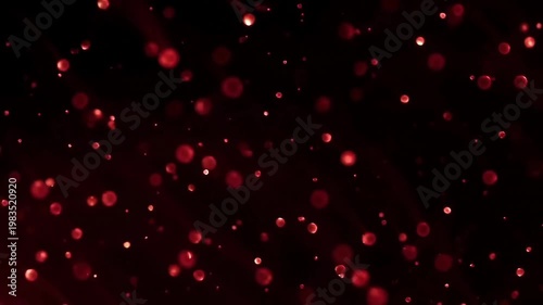 Vibrant red floating particles on deep black background abstract motion graphics