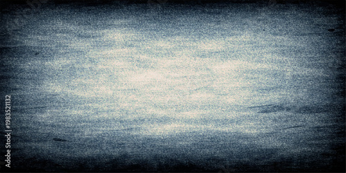 A dark blue grunge denim fabric texture provides a rough cotton material backdrop with a macro pattern and space for text in this closeup fashion design background