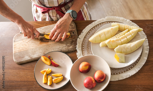 Woman Is Slicing Peaches And Melon