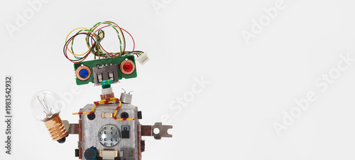 Simple kind funny toy robot with red and blue eye and multicolored wire hair holding a large light bulb. Inventor concept, idea poster, creativity banner