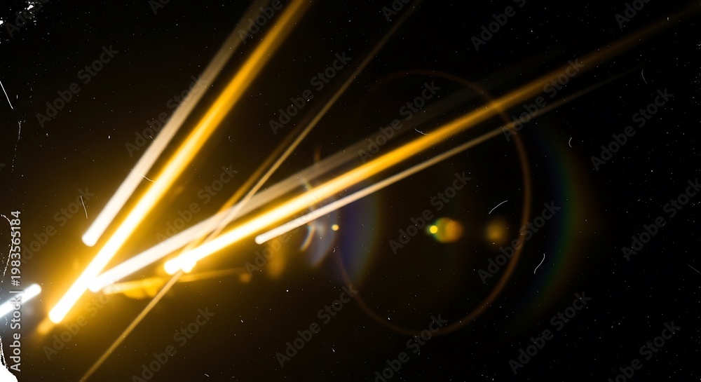 Fototapeta premium Abstract golden light streaks and lens flare effect captured against a deep black textured background