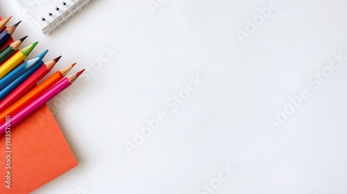 Colorful Crayons and Blank Paper on a Light Surface Ready for Drawing