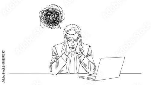 A stressed businessman sitting at his desk.