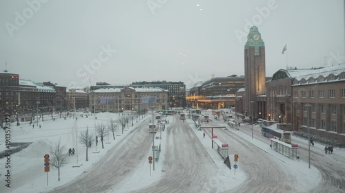 A serene winter scene showcasing a snow-covered urban area. The blend of historic and modern structures creates a picturesque backdrop, highlighting the beauty of the city in winter.