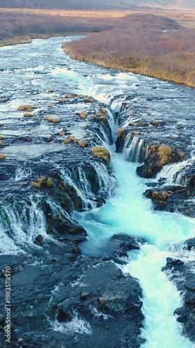 Epic Waterfall in scenic iceland nature, aerial shot - vertical video