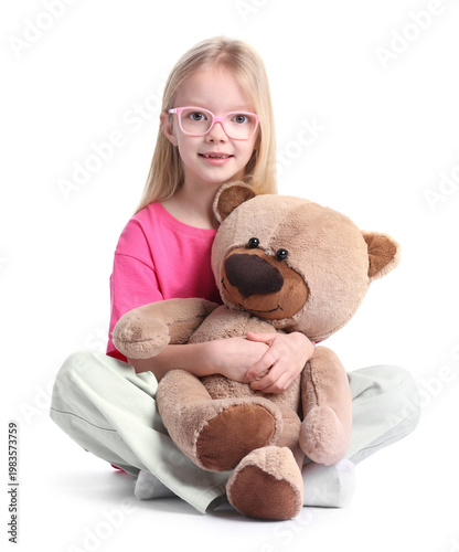 Schilderij op canvas Little girl hugging her teddy bear on white background