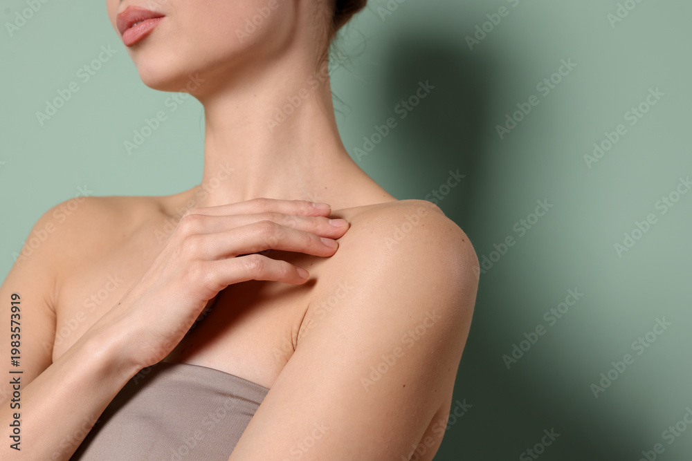 Obraz premium Woman against green background, closeup with space for text. Body care