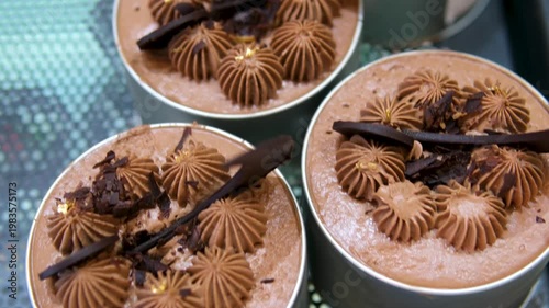 Chocolate mousse desserts Slicing a glossy chocolate mousse cake topped with cherry. Elegant gourmet dessert on white plate, perfect for pastry, food, or restaurant visuals.