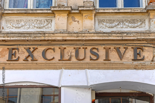 Fotografía 3d Sign Exclusive at Dilapidated Building Crumbling Facade Wall in Romania