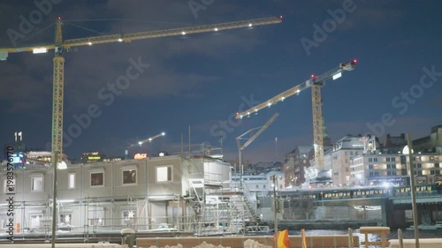 A bustling urban construction site featuring multiple cranes against a dusk sky, showcasing the evolution of modern architecture.
