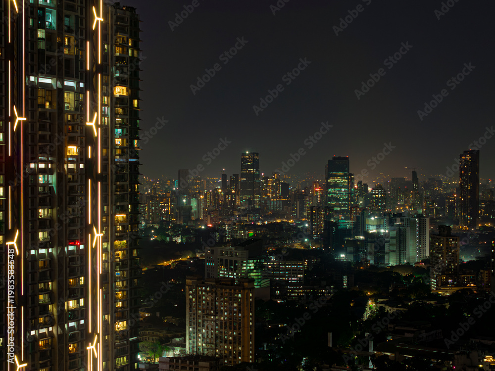 Fototapeta premium Cinematic view of Mumbai city at night. Mumbai's iconic financial district with this stunning cityscape view. Shot of Mumbai Skyline, high-rise buildings at South Mumbai, Maharashtra India.