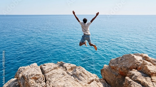 Man Jumps off Rocks Into the Ocean on a Bright Sunny Day by the Coast