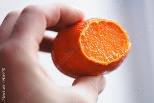 Картината върху платно A person grasping an orange in their hand, ideal for illustrations about food, n