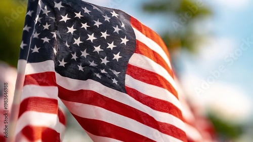 American Flag Waving Under Blue Sky on a Sunny Day During Outdoor Event