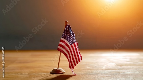 Small American Flag Standing on a Wooden Table With Warm Light in the Backgro...