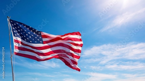 Bright American Flag Waving in the Wind Against a Clear Blue Sky During the D...