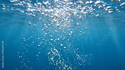 Underwater Bubbles Rising to Surface in Deep Blue Sea