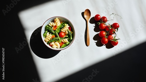 Fresh Pasta Salad With Cherry Tomatoes and Greens on a Table With Natural Light