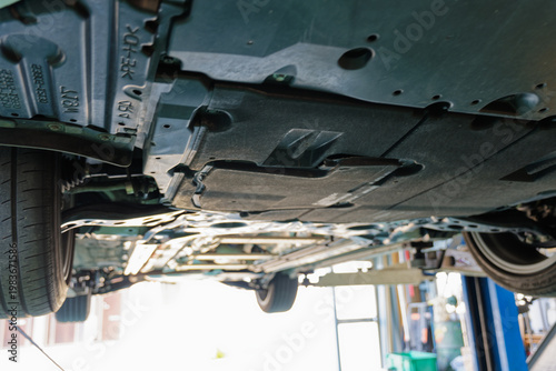 Canvas Print Underside of a passenger car lifted in an auto repair shop for vehicle inspectio