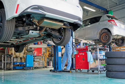 Photography Underside of a passenger car lifted in an auto repair shop for vehicle inspectio