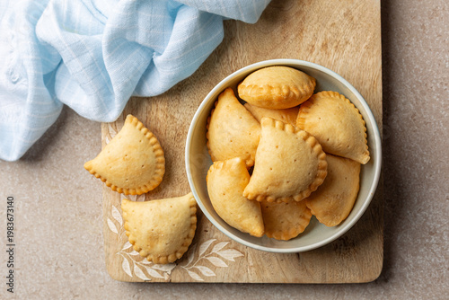 Фотография Plate with just Baked empanadas, pasty or panzerotti is a type of baked  turnover pastry and filling, common in Spain, Portugal, Italy,  Latin Amirican countries