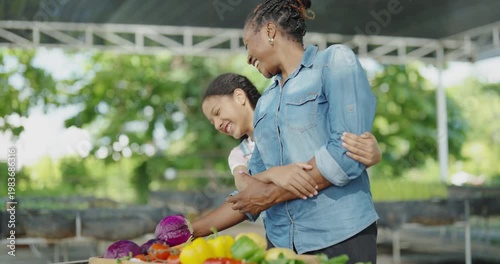 Agricultural concept of 4k resolution. African mother and daughter arranging vegetables in baskets at the garden.