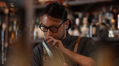 Night club concept of 4k Resolution. A bartender shakes a cocktail at the bar.