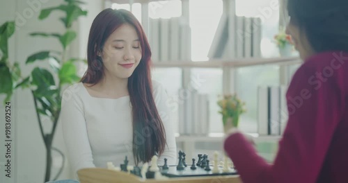 Wallpaper Mural Holiday concept of 4k Resolution. Asian women playing chess together in the house. Torontodigital.ca