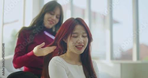 Holiday concept of 4k Resolution. Asian women combing their hair together in the house.