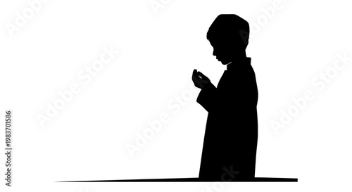 Silhouette of a Young Boy Praying with Hands Folded in Devotion and Reverence