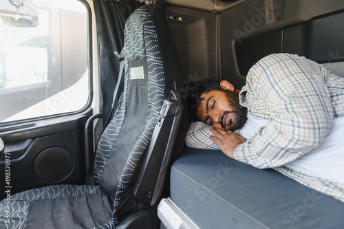 Foto Truck driver sleeping resting inside cab during break